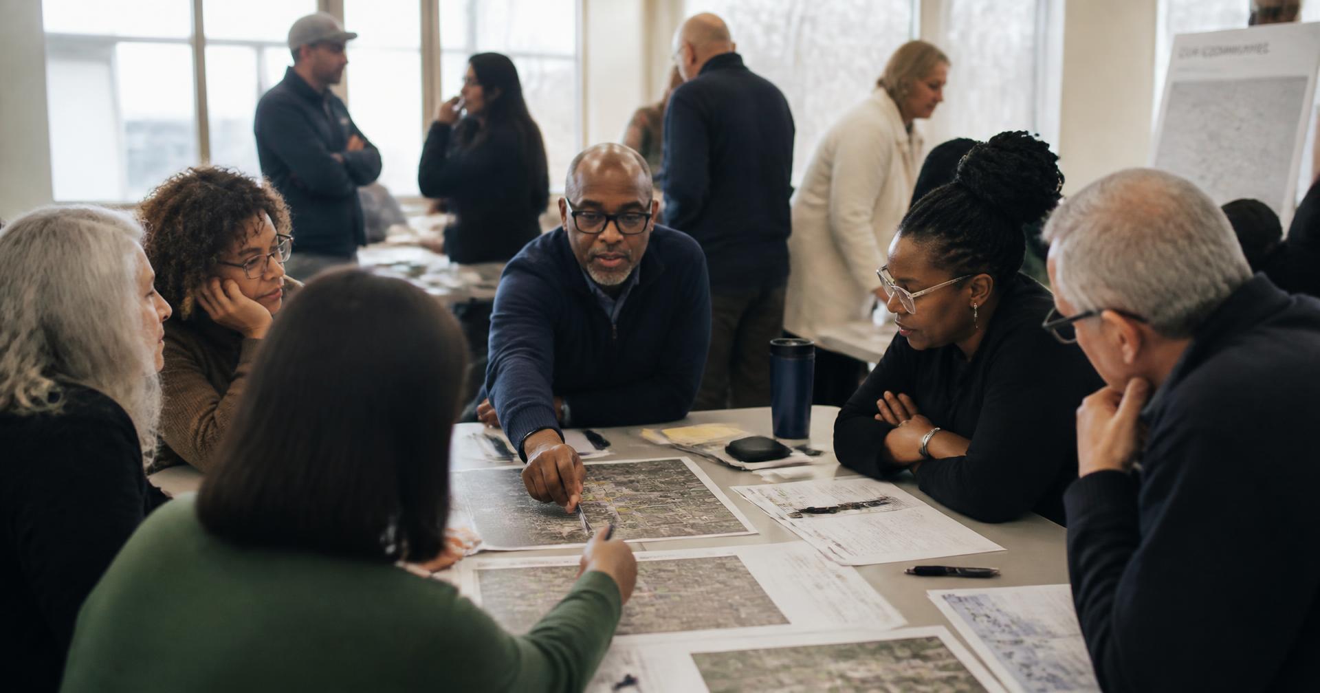 Entrepreneurs and community leaders working through plans in a working session